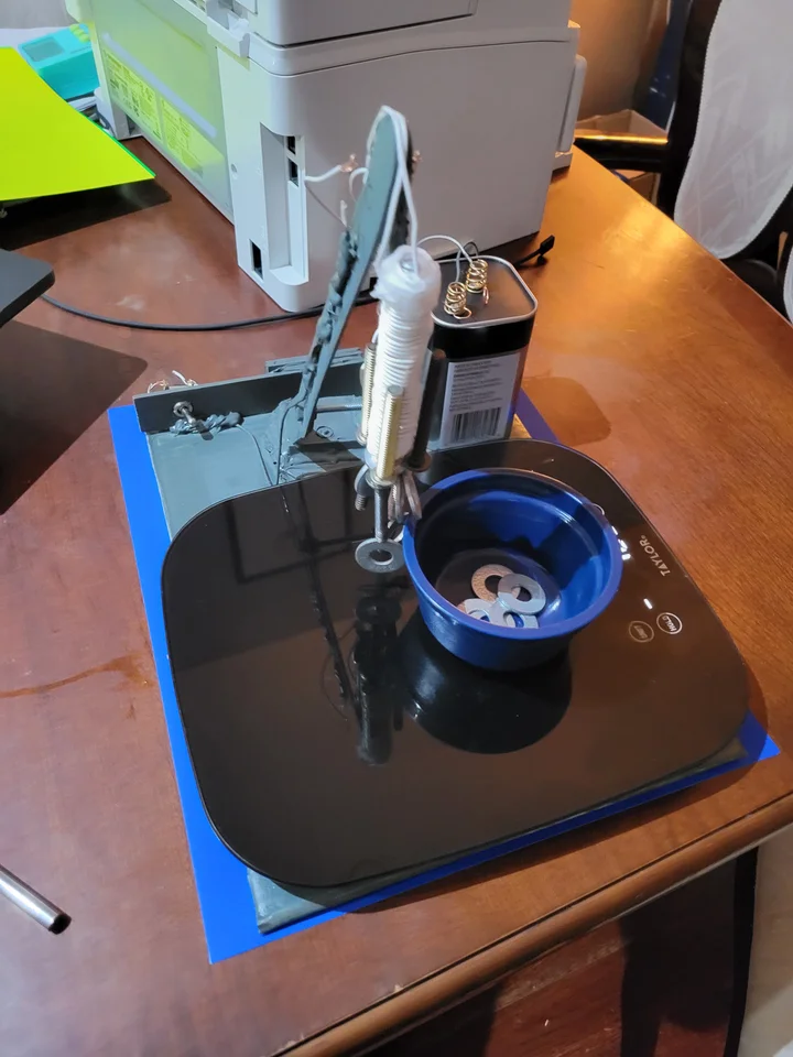 My electromagnetic crane lifting a washer during a test on a digital scale.