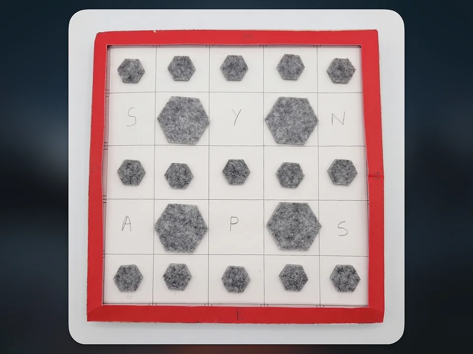 Top-down view of my handmade Synapse memory-game board, with a red frame and felt tiles.
